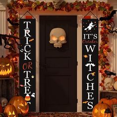 halloween decorations with pumpkins and jack - o'- lanterns in front of a black door