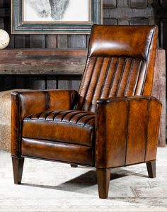 a brown leather recliner chair sitting in front of a fireplace