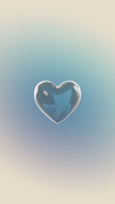 a heart shaped object floating in the air with blue and white colors on it's surface