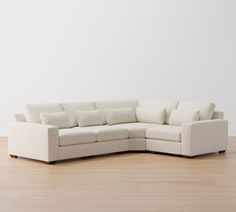 a white couch sitting on top of a hard wood floor