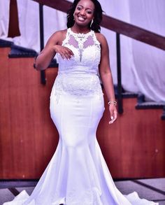 a woman in a white dress posing for the camera