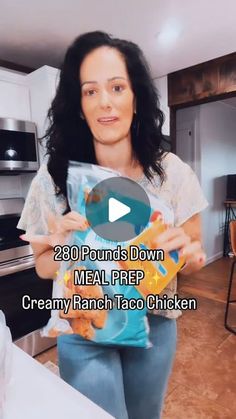 a woman holding up a bag of food in her kitchen with the caption, 28 pounds down meal prep creamy ranch taco chicken