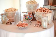 a table topped with lots of different types of candy and candies on top of it