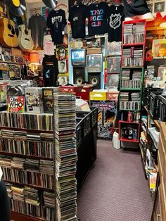 a room filled with lots of different types of records and cds on shelves next to each other