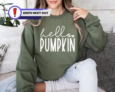 Hello Pumpkin Sweatshirt, Fall Sweatshirts for Women, Pumpkin Crewneck, Cute Fall Hoodie Fall Apparel, Pumpkin Season Sweatshirt and Hoodie Product Features Material: Crafted from a premium 50/50 blend of cotton and polyester, our apparel offers the ideal combination of comfort and warmth. The soft, breathable fabric ensures you remain cozy without feeling weighed down, making it a perfect choice for any season. Fit: Designed with unisex sizing, our apparel provides a relaxed, comfortable fit for everyone. Whether you're lounging at home or out and about, you'll appreciate the easygoing style and versatility of this piece. Specifications: Weight: 8.0 oz./yd² (271.25 g/m²) Air Jet Yarn: This technology ensures a softer feel and significantly reduces pilling, keeping your apparel looking fre Fall Crew Neck Hoodie With Comfortable Fit, Comfortable Fit Graphic Hoodie For Fall, Comfortable Crew Neck Hoodie For Fall, Green Letter Print Hoodie For Fall, Pumpkin Crewneck, Fall Shirts For Women, Fall Tshirt, Cute Fall Shirt, Fall Apparel