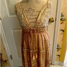 Beautiful Halter Dress, New With Tags, Tan With Embroidery Gold Thread And Sequences. Adjustable One Size Fits All With Adjustable Straps. Beige Summer Dress With Intricate Embroidery, Beige Intricately Embroidered Summer Dress, Embroidered Flowy Sleeveless Dresses, Embroidered Sleeveless Flowy Dresses, Flowy Sleeveless Embroidered Dress, Flowy Embroidered Sleeveless Dress, Sleeveless Embroidered Beige Dress, Bohemian Sleeveless Embroidered Midi Dress, Bohemian Embroidered Sleeveless Midi Dress