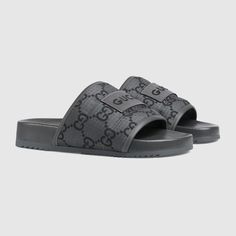 "Find GUCCI Gg Slide Sandal Nylon on Editorialist. Inspired by the summer spirit and beach clubs on the Italian coast, this item is part of Gucci Lido. This pair of men's slide sandal is crafted in GG ripstop and defined by a Gucci label on the front, adding a bold logo feel to the style. Black GG ripstop recycled polyester, Men's, Leather trim, \"Gucci Made in Italy\" embroidered label, Rubber sole, Flat, Made in Italy" Luxury Summer Slides With Rubber Sole, Designer Slides With Branded Insole For Beach, Designer Beach Slides With Branded Insole, Designer Leather Slides For The Beach, Black Sandals For Summer Travel, Black Travel Sandals For Summer, Gucci Slip-on Sandals With Rubber Sole, Gucci Sandals With Rubber Sole For Summer, Gucci Casual Sandals With Cushioned Footbed