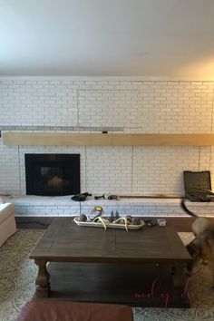 a living room filled with furniture and a flat screen tv mounted on a wall above a fireplace