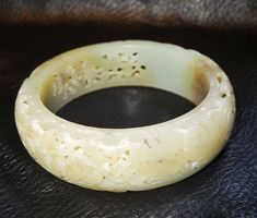 A fine quality antique nephrite jade bangle with very fine double carving This is hetian jade from the Khotan province. The color is a white with tan areas and the carving is excellent. Qing Dynasty late 18th/early 19th century. It has a fatty luster and smooth finish. The carving in unusual in that it combines lace-like openwork carving with a double carved panel. The bangle measures a little under 1 inch wide (19 mm) with an inside diameter of 2.5 inches (62 mm). It is in very good antique con Arm Bangles, Jade Bangle Bracelet, Antique Jade, Antique Finds, Jade Dragon, Hetian Jade, Chinese Hanfu, Jewelry Website, Jade Bangle