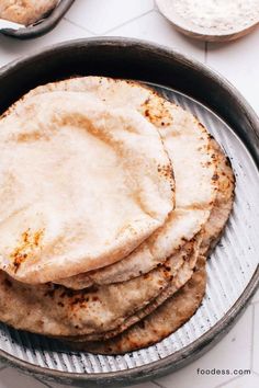 a pan filled with tortillas sitting on top of a table