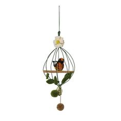 a bird is sitting in a cage with flowers on the top and one branch hanging from it's side