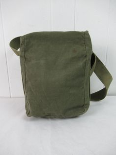 "Unique vintage 1940s WWII era green cotton canvas shoulder bag. Has unique tie down closures. Maybe a hunting bag or military bag. No manufacturer's label. Bag measures 12\" tall, 8\" wide and 4.5\" thick. In very good condition with name written in marker on the strap." Vintage Green Satchel Shoulder Bag, Vintage Green School Bag, Green Vintage School Bag, Vintage Green Shoulder Bag For Everyday, Vintage Green Satchel With Adjustable Strap, Vintage Canvas Satchel Bag For Everyday, Vintage Satchel Canvas Bag For Everyday, Vintage Green Canvas Bag For Travel, Vintage Khaki Shoulder Bag For Everyday