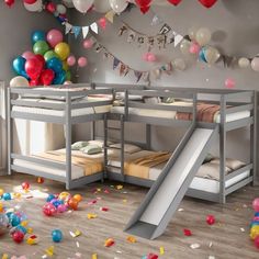 there are balloons and streamers all over the floor in this room with bunk beds