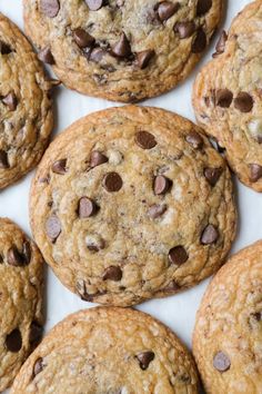 chocolate chip cookies arranged on top of each other with one cookie in the middle surrounded by smaller ones