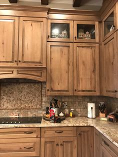 a kitchen with wooden cabinets and granite counter tops