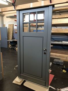 a small gray door sitting in the middle of a room