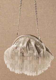 Opt for an effervescent pouch to tote your wedding day necessities with this flamboyant design adorned with a shower of pearlescent tassels. crystals, brocade lining magnetic snap-clasp closure 9"L x 3"W x 7"H 16" strap Gatsby Glam, Wedding Accessories For Bride, Bridal Clutch Bag, Faux Fur Wrap, Bridal Bag, Bridal Clutch, Tassel Bag, Beaded Bags, Beaded Tassels