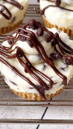 chocolate and white frosted cupcakes sitting on a cooling rack