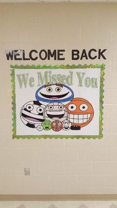 a welcome back sign is hanging on the wall