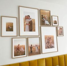 a wall with many pictures hanging on it's side and some people holding each other