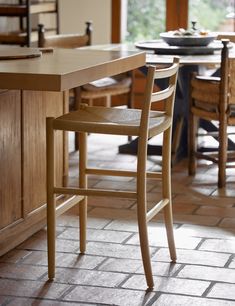 a wooden chair sitting next to a counter in a kitchen