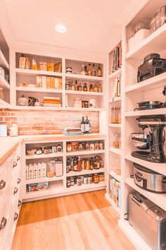 a kitchen with lots of shelves filled with pots and pans