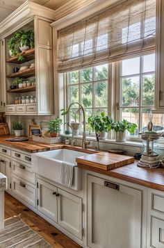 a kitchen with white cabinets and wooden counter tops, along with an island in the middle