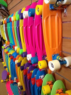 colorful surfboards are lined up on the wall