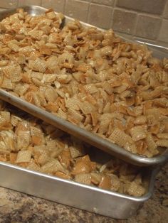 two metal pans filled with food on top of a counter