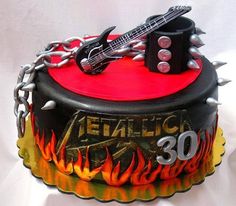 a birthday cake with an electric guitar on it's top and chains around the edges