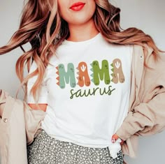 a woman wearing a t - shirt that says mom sauvrs on it