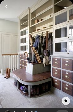 the closet is filled with lots of coats and other items, including an umbrella rack