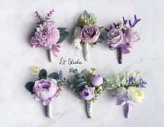 six boutonnieres with different flowers on them