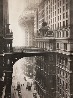 an old black and white photo of a bridge over a city street