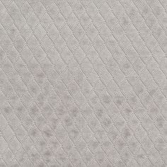 an upholstered fabric textured with small dots and lines in light grey color