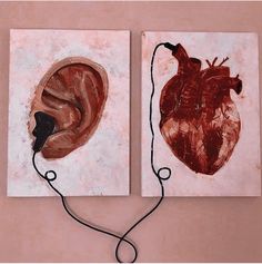 two pieces of art that look like they have earbuds attached to the wall