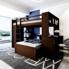 a bunk bed sitting next to a window in a room with a rug on the floor