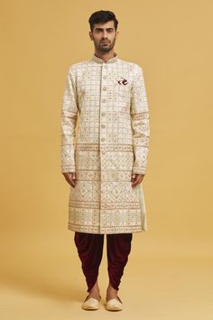 Cream sherwani with embroidered floral and honeycomb patterns. Comes with velvet dhoti pant.
Components: 2
Pattern: Embroidered
Type Of Work: Floral, Honeycomb
Neckline: Mandarin Collar
Sleeve Type: Full
Fabric: Sherwani: Jaquard Chikankari Lucknawi, Dhoti Pant: Velvet
Color: Cream
Other Details: 
Closure: Sherwani: Button
Note: Pocket square worn by model is not for sale
Occasion: Mehendi and Puja,Sangeet - Aza Fashions Eid Sherwani With Resham Embroidery For Traditional Ceremonies, Jamawar Sherwani With Intricate Embroidery For Traditional Ceremonies, Intricate Embroidered Jamawar Sherwani For Traditional Ceremonies, Traditional Sherwani With Intricate Embroidery For Eid, Eid Sherwani With Intricate Embroidery And Traditional Drape, Intricate Embroidered Sherwani For Eid, Eid Sherwani With Intricate Embroidery, Traditional Drape Jamawar Sherwani With Chikankari Embroidery, Traditional Sherwani With Naqshi For Transitional Seasons