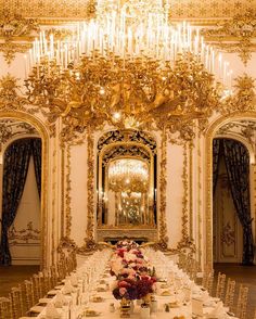 a fancy dining room with chandelier and tables set up for a formal dinner