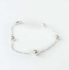 "Delicate chain bracelet with balls, handmade in 925 sterling silver. Minimalist design for everyday wear and ideal for use in layers with other bracelet. ♥ Details: Metal type: Sterling silver Karat / purity: 925 Bracelet length: 5\", 5.5\", 6\", 6.5\", 7\", 7.5\" ♥ Packaging: Free Gift Wrapping! All jewels come in a beautiful package with a bow, ready to give away. Dimensions: 3.50 x 3.50 x 0.87 Inches ♥ Do you have a question? Feel free to contact me directly by sending me a message. ♥♥ We ma Everyday Bracelet, Ball Bracelet, Free Gift Wrapping, Minimalist Jewelry, Beaded Chain, Chain Link Bracelet, Silver Bracelets, Chain Bracelet, Types Of Metal