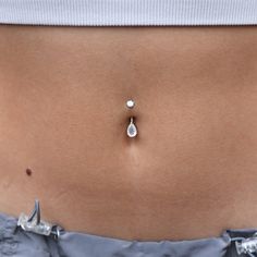 a woman's stomach with a small diamond in the middle of her tummy