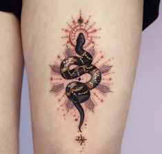 a woman's thigh with a snake tattoo on the lower part of her leg