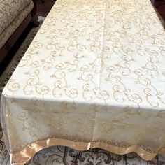 a white table cloth with gold designs on it