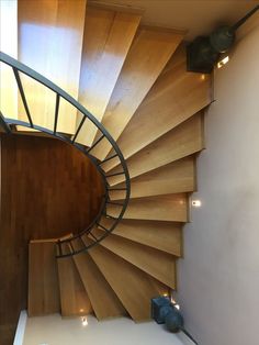 a spiral staircase in a house with wooden floors