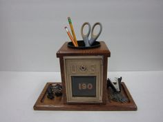 a desk clock with scissors and pencils in it