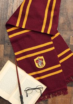 a harry potter scarf with glasses and an open book