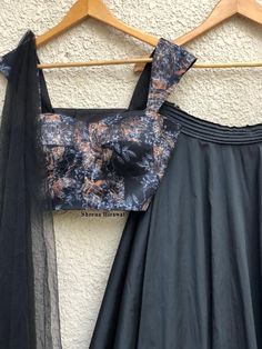 Black printed bustier with intricate florals teamed with a black taffeta skirt and tulle dupatta. Fabric: Blouse- Crepe Skirt- Tafetta Dupatta- Tulle Note: Can be customized as per color and size as well Care Instructions: Steam iron & Dry clean only Size Chart (In Inches): XS S M L XL Chest 32 34 36 38 40 Waist 26 28 30 32 34 Hip 34 36 38 40 42 The product will be shipped within 6-8 weeks of the order placed. Black Taffeta Skirt, Yellow Floral Skirt, Black Velvet Blouse, Taffeta Skirt, Floral Bustier, Black Floral Blouse, Myanmar Dress Design, Crepe Skirts, Indian Wedding Wear