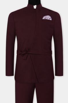 Exude timeless charm and sophistication with our Umber Maroon Wool Rich Bandhgala Designer Suit, featuring concealed pockets and a belt closure for the perfect fusion of style and convenience! The rich Umber Maroon hue adds a touch of regal allure, making you the center of attention at any event. Crafted with premium wool-rich fabric, it ensures unmatched comfort and luxury. The concealed pockets add a modern and sleek touch, while the belt closure accentuates your silhouette, creating a disting Elegant Formal Blazer With Belt, Elegant Fitted Blazer With Belt Detail, Tailored Formal Blazer With Belt, Tailored Belted Blazer For Formal Occasions, Semi-formal Fitted Belted Blazer, Formal Blazer With Belt And Notch Lapel, Formal Notch Lapel Blazer With Belt, Elegant Long Sleeve Belted Suit, Tailored Suits With Belt Loops For Semi-formal Occasions