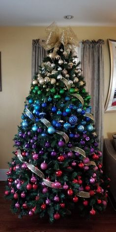 a brightly colored christmas tree in a living room