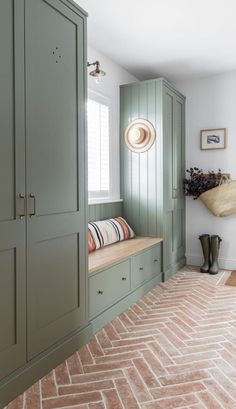 a room with green cupboards and a white rug on the floor in front of it